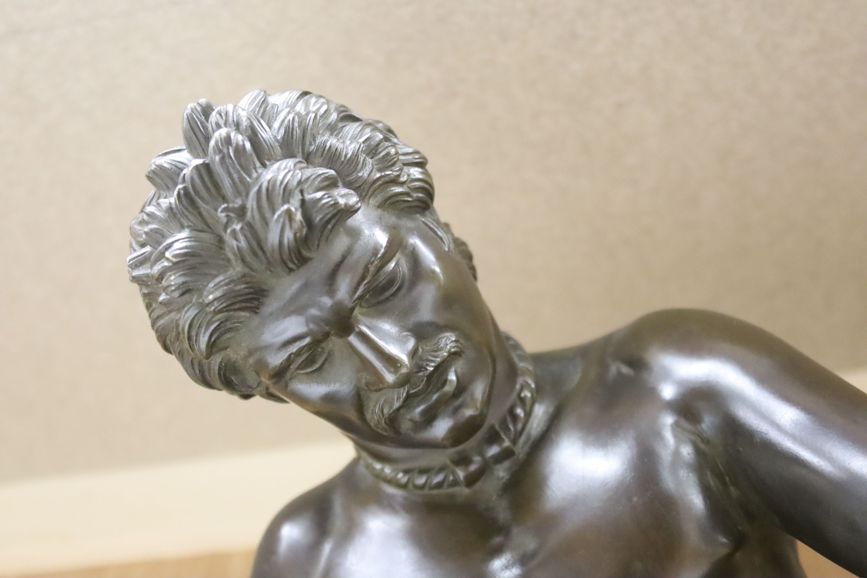 After the Antique, a large bronze figure of 'The Dying Gaul', on a marble plinth, length 55cm